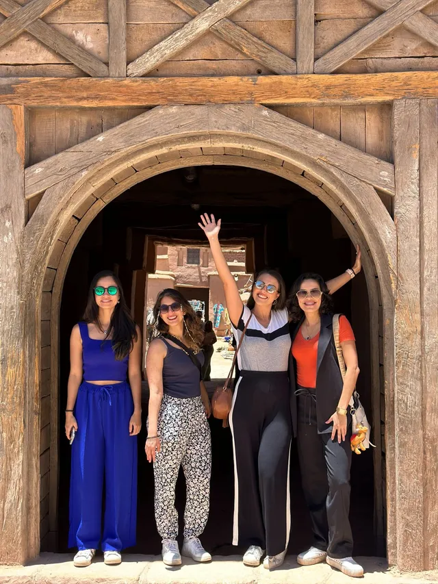 Grupo de jovens viajantes num portal de kasbah no Marrocos